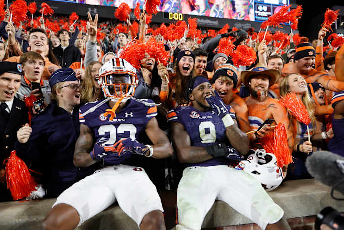 Oct 30, 2021; Auburn, Alabama, USA; Auburn Tigers cornerback Trey Elston (22) and linebacker Zakoby McClain (9) celebrate with fans defeating the Mississippi Rebels at Jordan-Hare Stadium. Mandatory Credit: John Reed-USA TODAY Sports generic